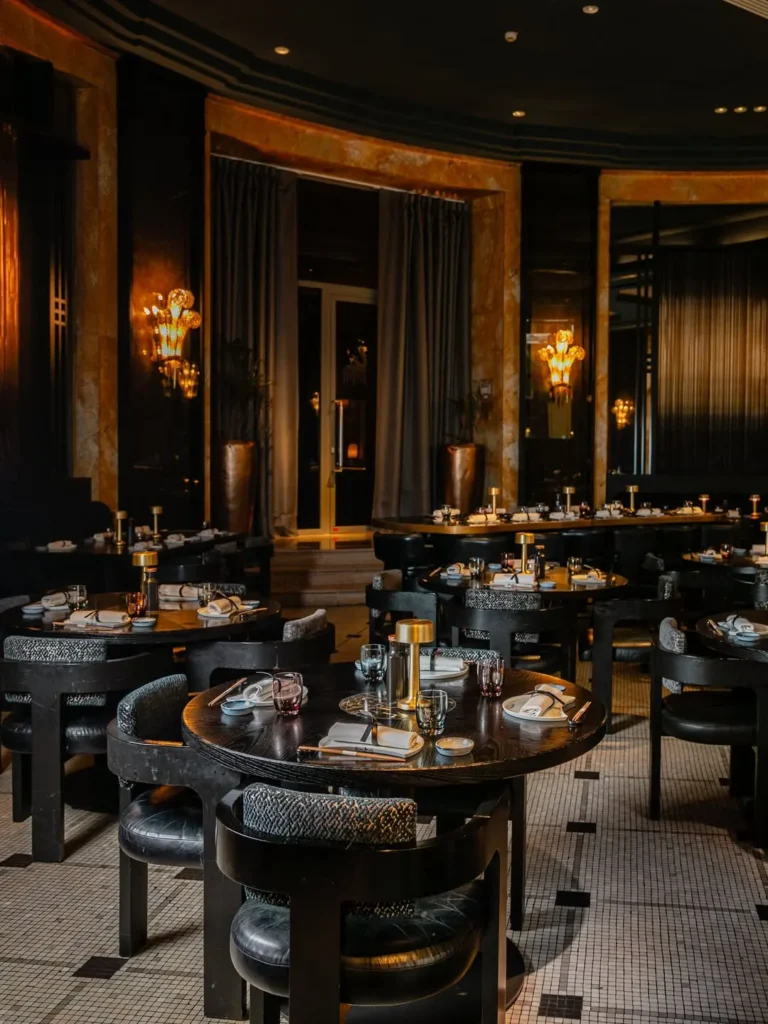 Elegant dining room with dark interiors at the Prince de Galles Paris