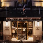 Illuminated entrance of the Prince de Galles Paris hotel at night