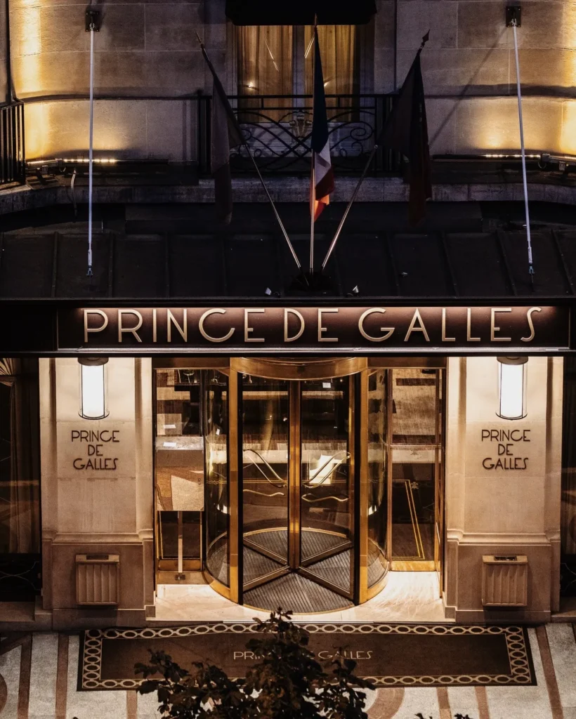 Illuminated entrance of the Prince de Galles Paris hotel at night