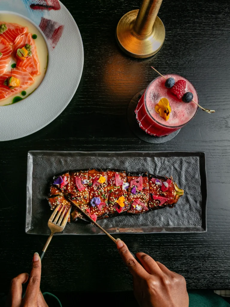 Colorful gourmet dish and cocktail at the Prince de Galles Paris