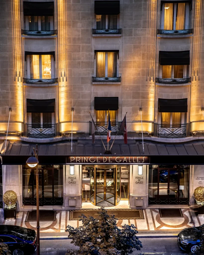 Illuminated entrance of the Prince de Galles Paris hotel at night
