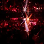 Guests dancing under red lights at Raspoutine Dubai