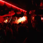 Red-lit nightclub interior at Raspoutine Dubai