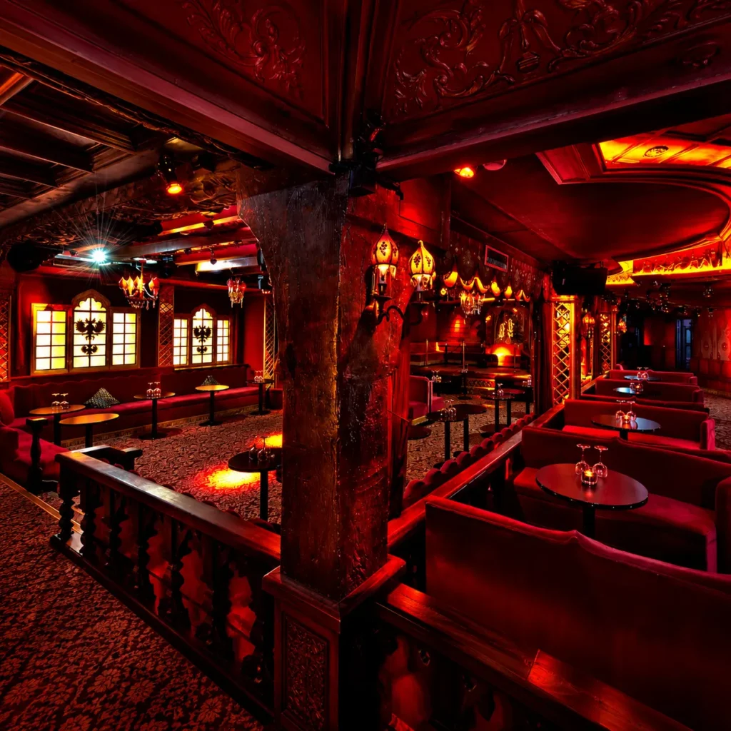 Elegant red-lit interior of Raspoutine Paris nightclub
