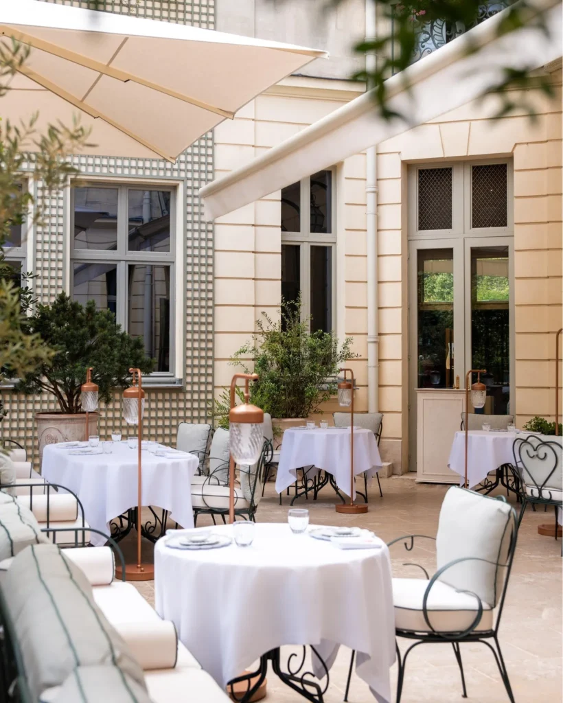 Elegant courtyard terrace with outdoor dining at the Ritz Paris