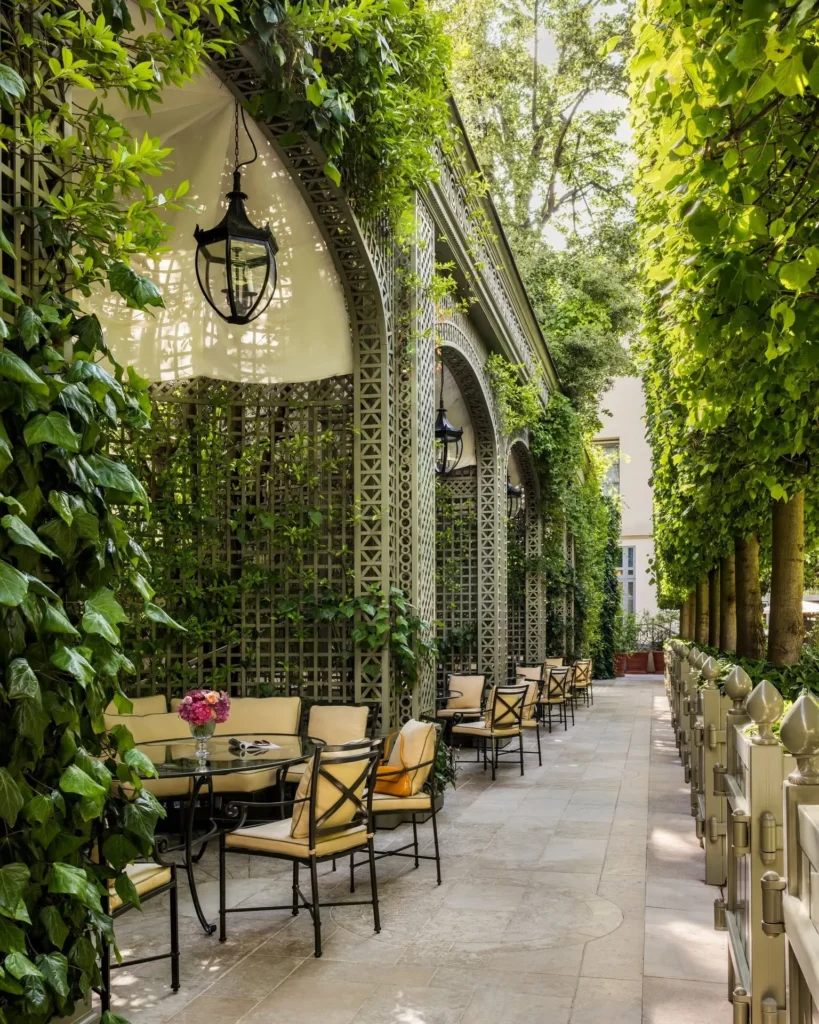 Lush garden terrace with outdoor seating at the Ritz Paris