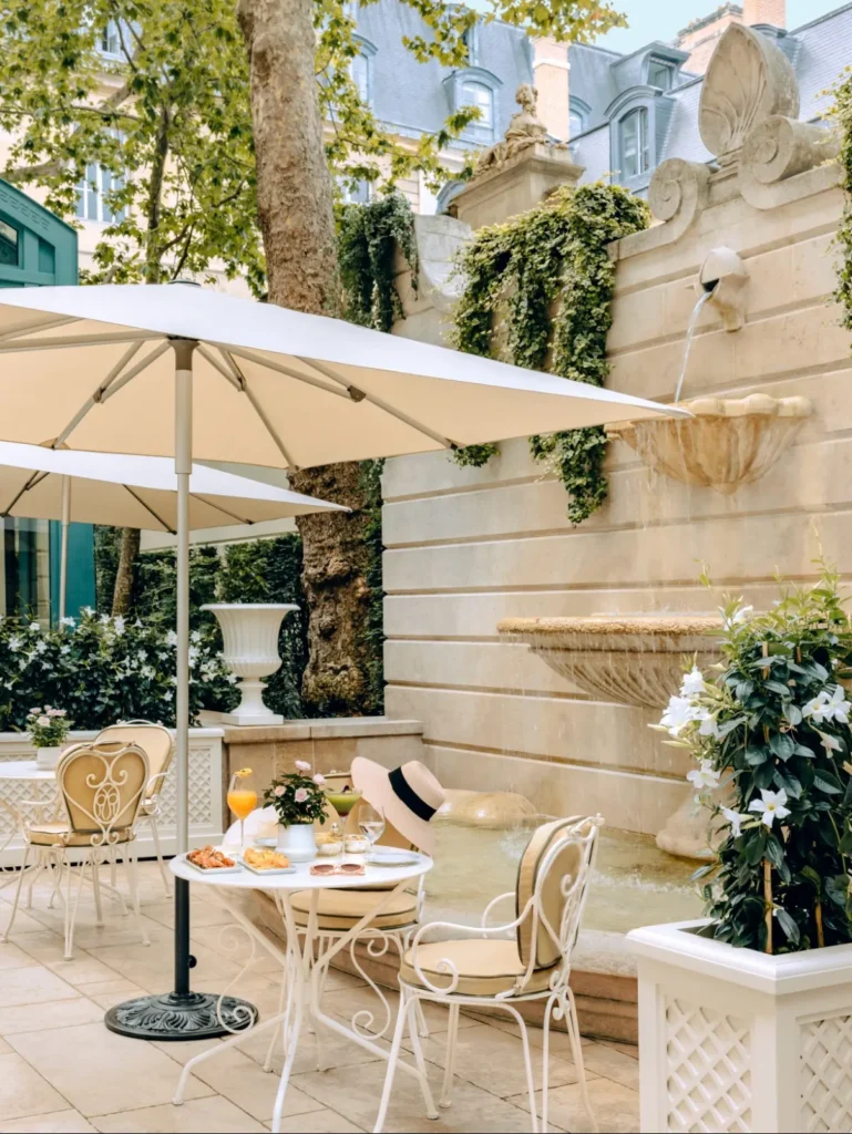 Secluded garden terrace with outdoor seating at the Ritz Paris