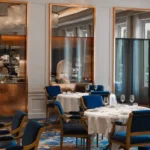 Elegant restaurant interior with blue chairs at the Ritz Paris