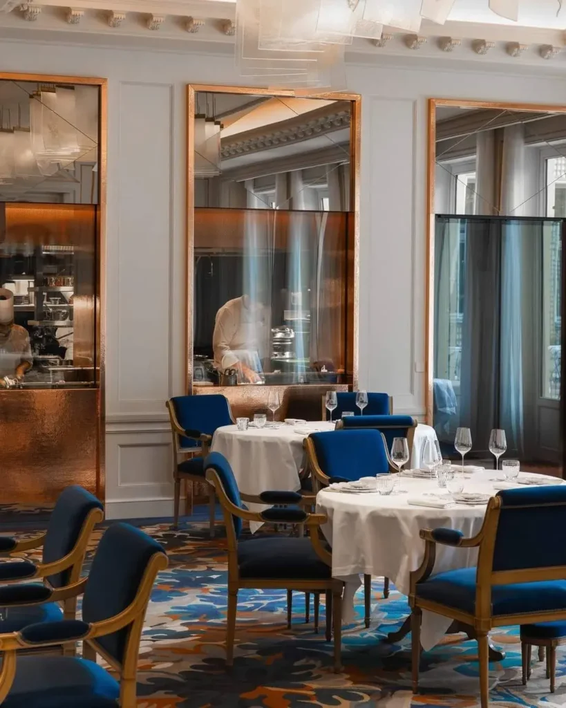 Elegant restaurant interior with blue chairs at the Ritz Paris