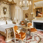 Ornate bedroom and sitting area inside a Ritz Paris suite