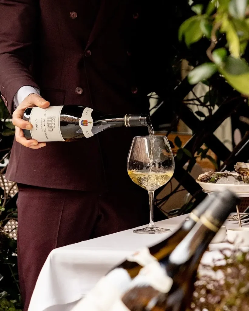 Champagne being poured at a table inside Scott's Mayfair