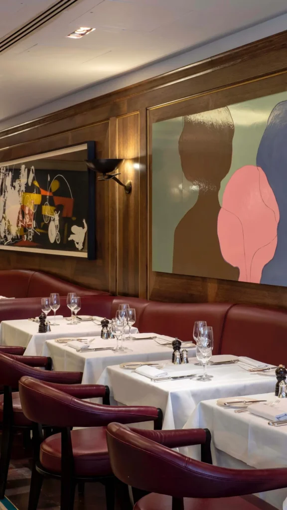 Elegant dining room with red upholstered seating at Scott's Mayfair