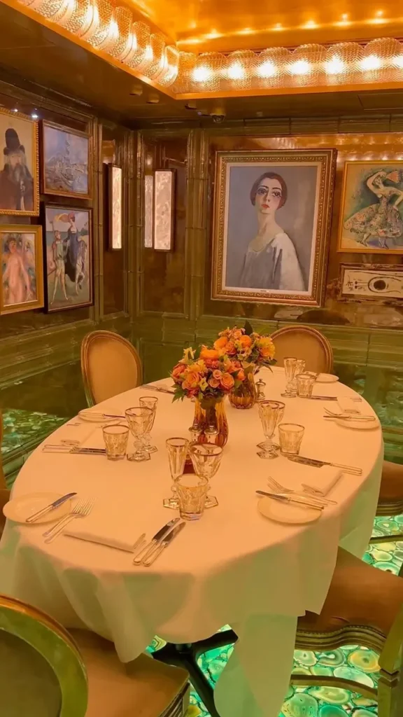 Private dining room with artwork and a round table at Scott's Mayfair