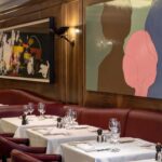Artwork and elegant dining room interior at Scott's Mayfair in London
