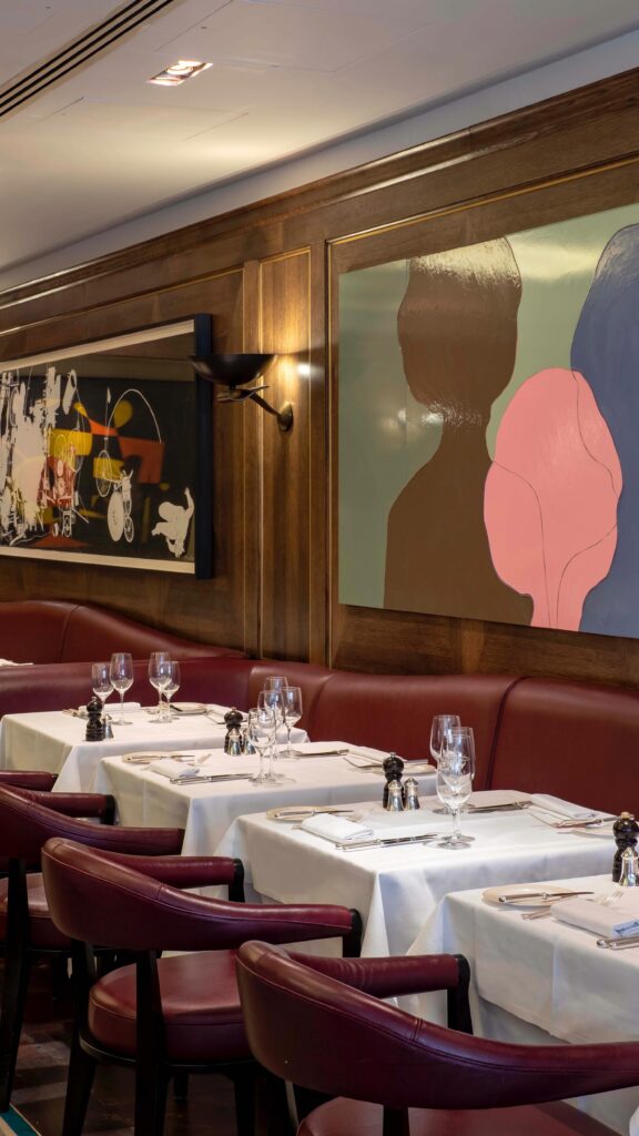 Artwork and elegant dining room interior at Scott's Mayfair in London