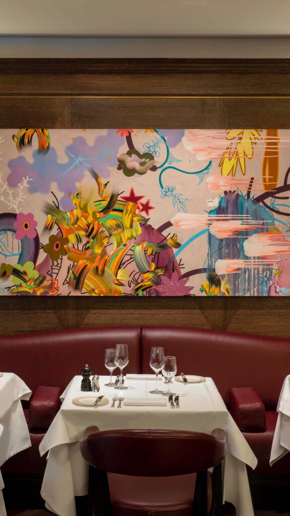 Elegant dining booth with colorful artwork at Scott's Mayfair in London