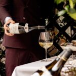 Wine being poured at a table at Scott's Mayfair restaurant in London