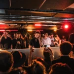 Guests dancing on the illuminated dance floor at Silencio Club Paris