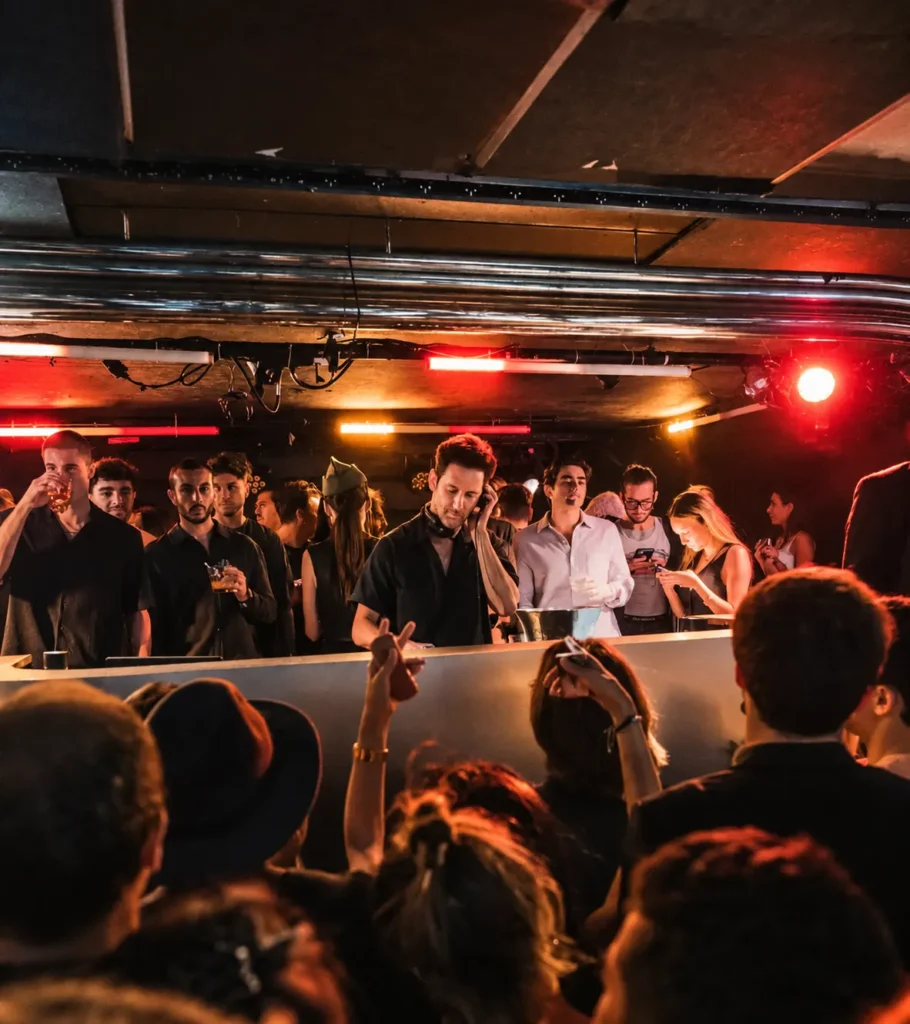 Guests dancing on the illuminated dance floor at Silencio Club Paris