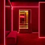 Red illuminated corridor inside Silencio Club Paris