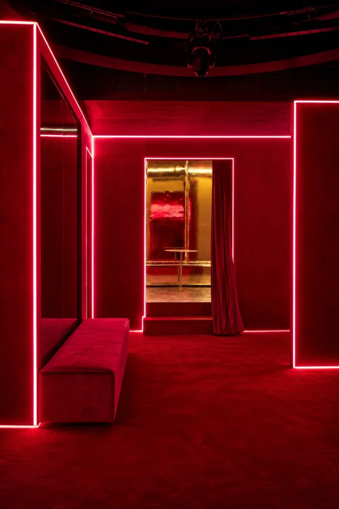 Red illuminated corridor inside Silencio Club Paris