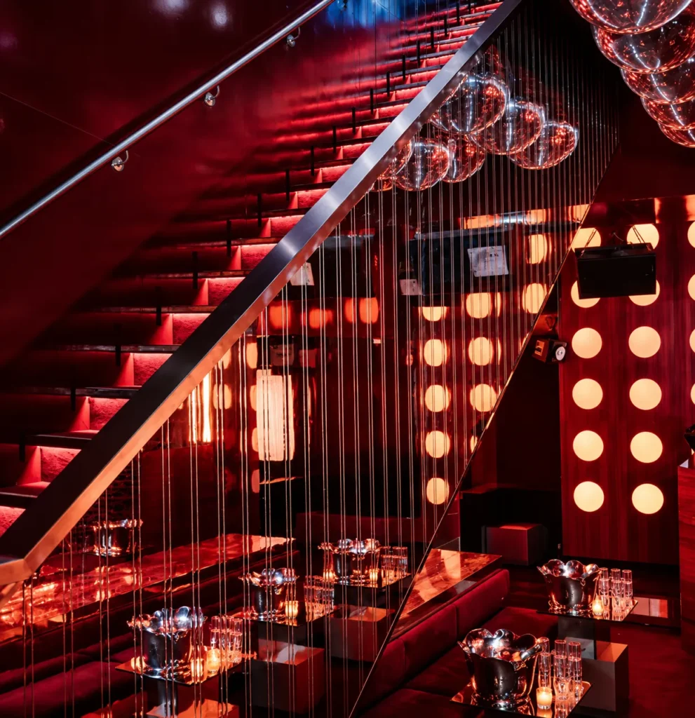 Dramatic staircase and illuminated interior at Silencio Club Paris