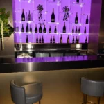 Purple-lit bar area inside STK Milan