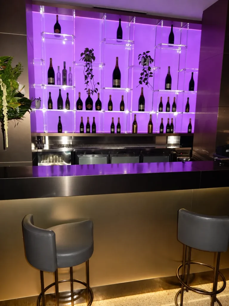 Purple-lit bar area inside STK Milan