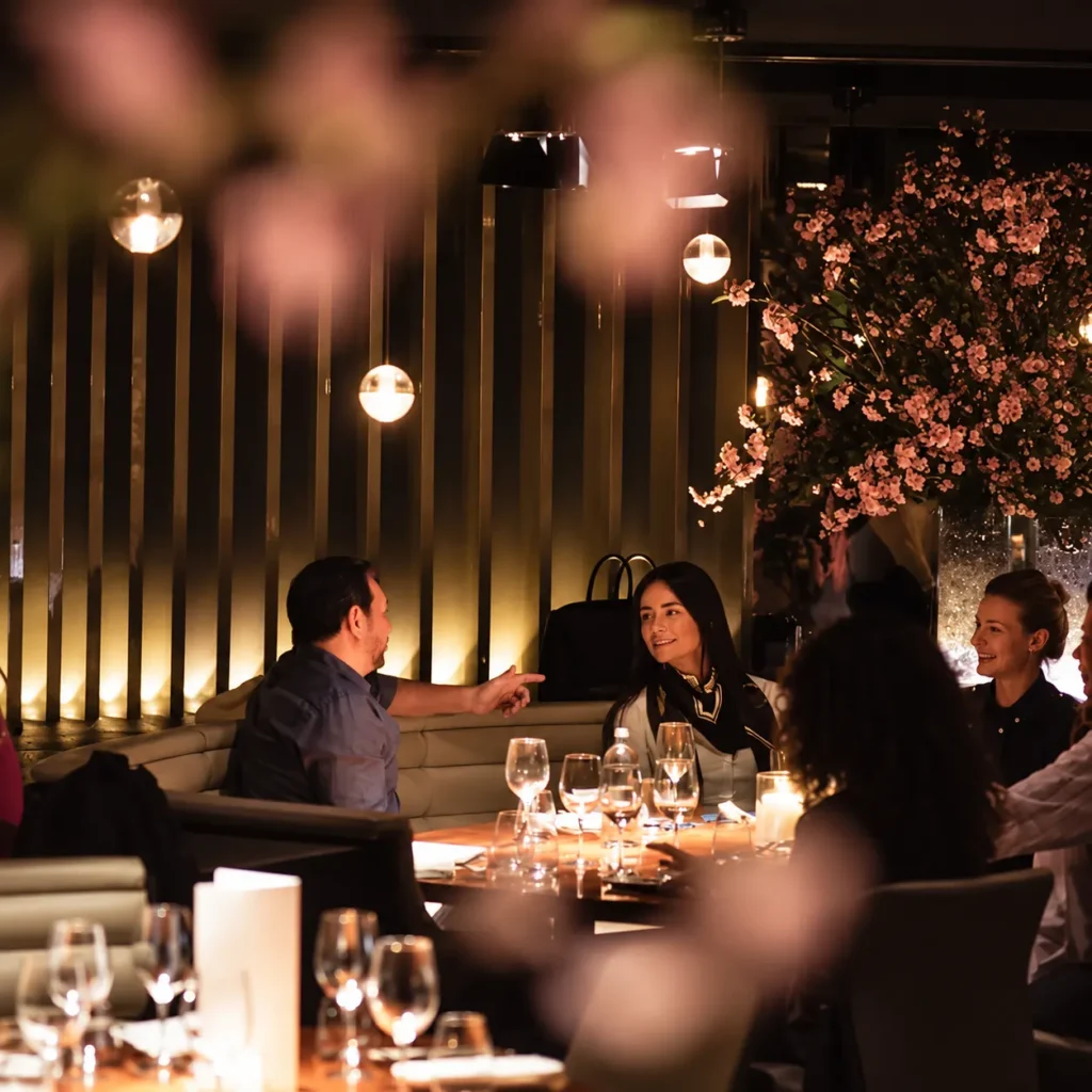 Guests dining together inside STK Milan
