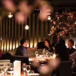 Guests dining together inside STK Milan