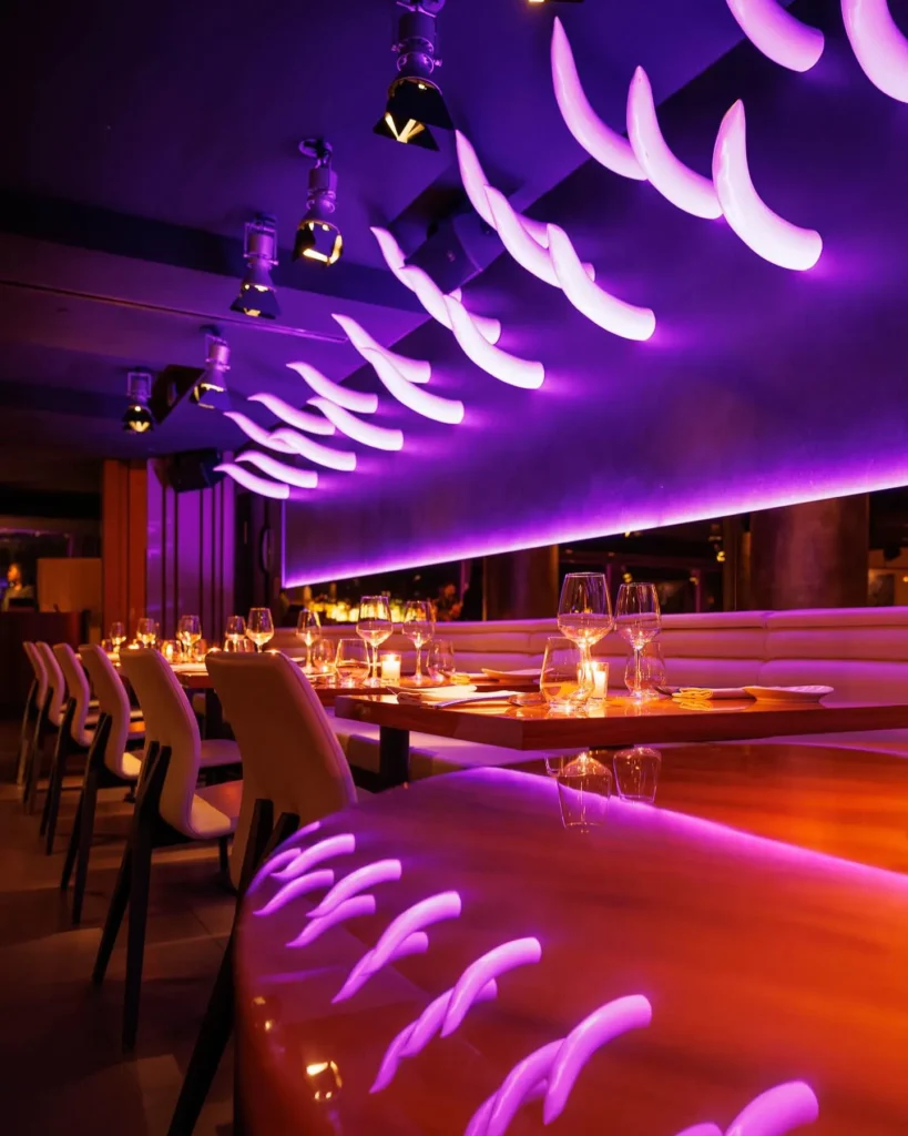 Purple-lit dining interior at STK Milan