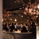 Warmly lit dining room with guests at STK Milan