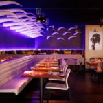 Modern dining room with purple lighting at STK Milan