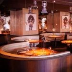 Private dining area with a bar and warm lighting at STK Milan