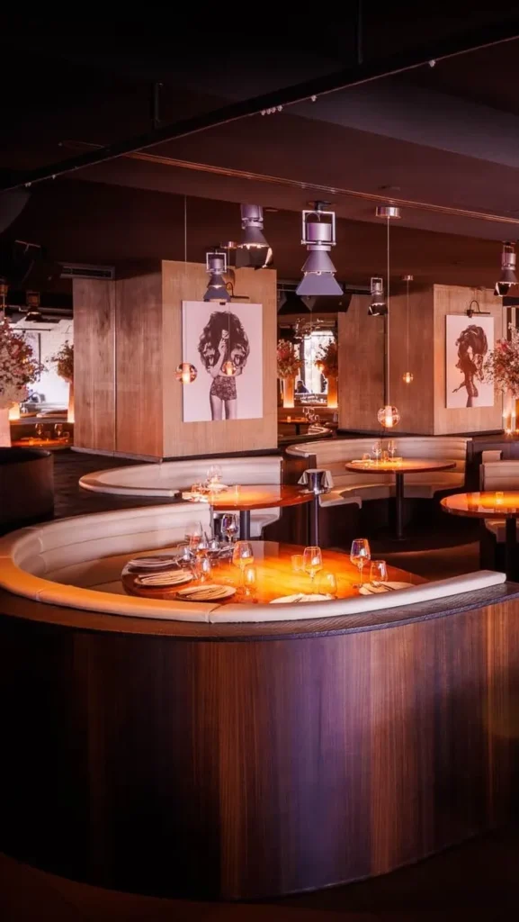 Private dining area with a bar and warm lighting at STK Milan