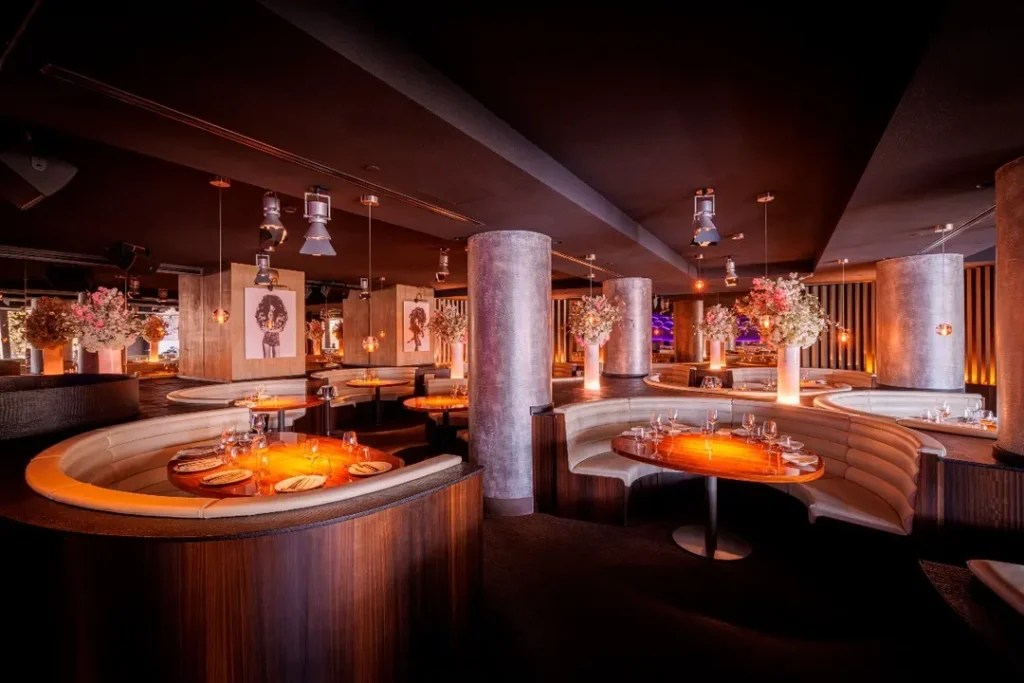 Private dining room with a bar and curved seating at STK Milan