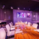 Elegant private dining room with purple lighting at STK Milan