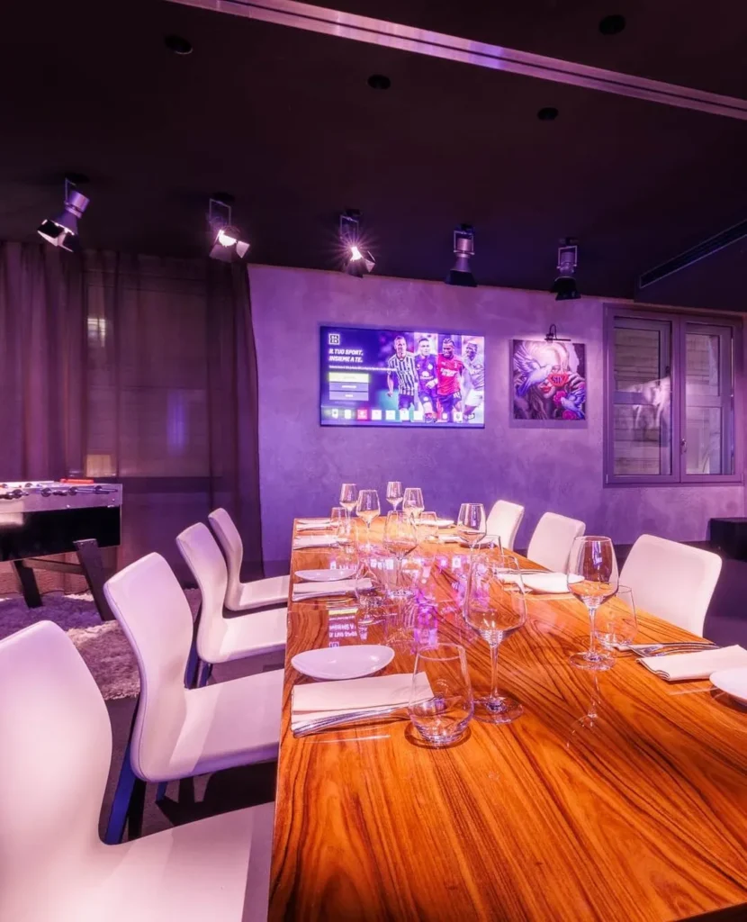 Elegant private dining room with purple lighting at STK Milan