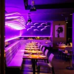 Purple-lit restaurant interior at STK Milan