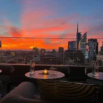Rooftop dining area at STK Milan overlooking the Milan skyline at sunset