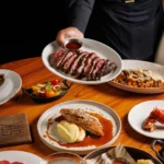 Steak platter with side dishes served at STK Milan