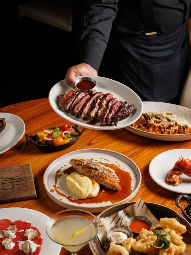 Steak platter with side dishes served at STK Milan