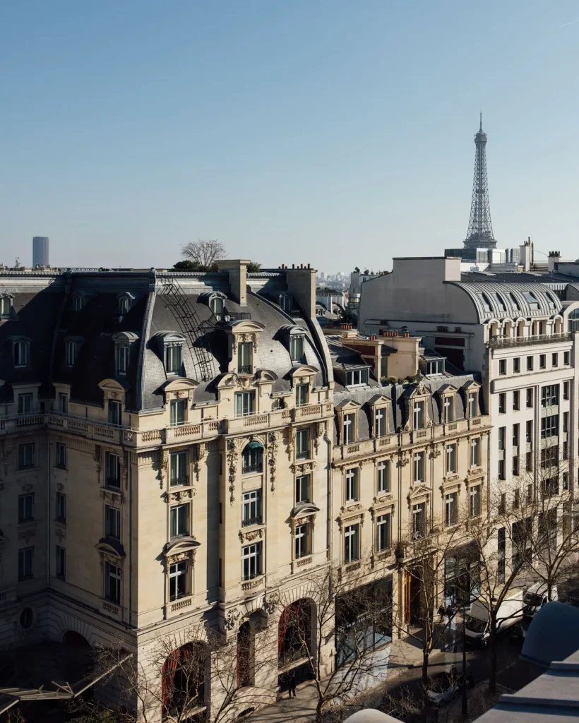 The Peninsula Paris building with the Eiffel Tower visible in the distance