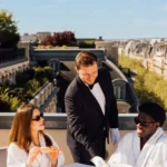 Guests dining on a rooftop terrace with Paris views at The Peninsula Paris