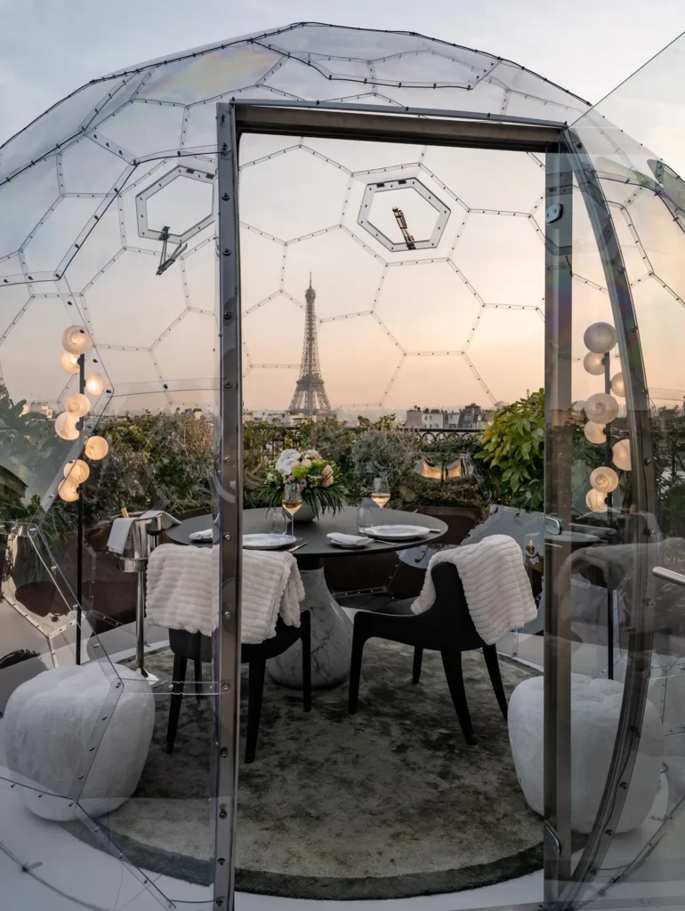 Elegant table setting inside a rooftop dining dome at The Peninsula Paris