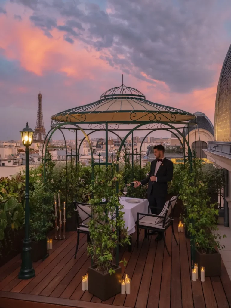 Rooftop dining terrace at sunset with the Eiffel Tower at The Peninsula Paris