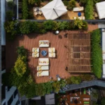 Aerial view of the landscaped garden courtyard with outdoor dining areas at Bulgari Hotel Milano