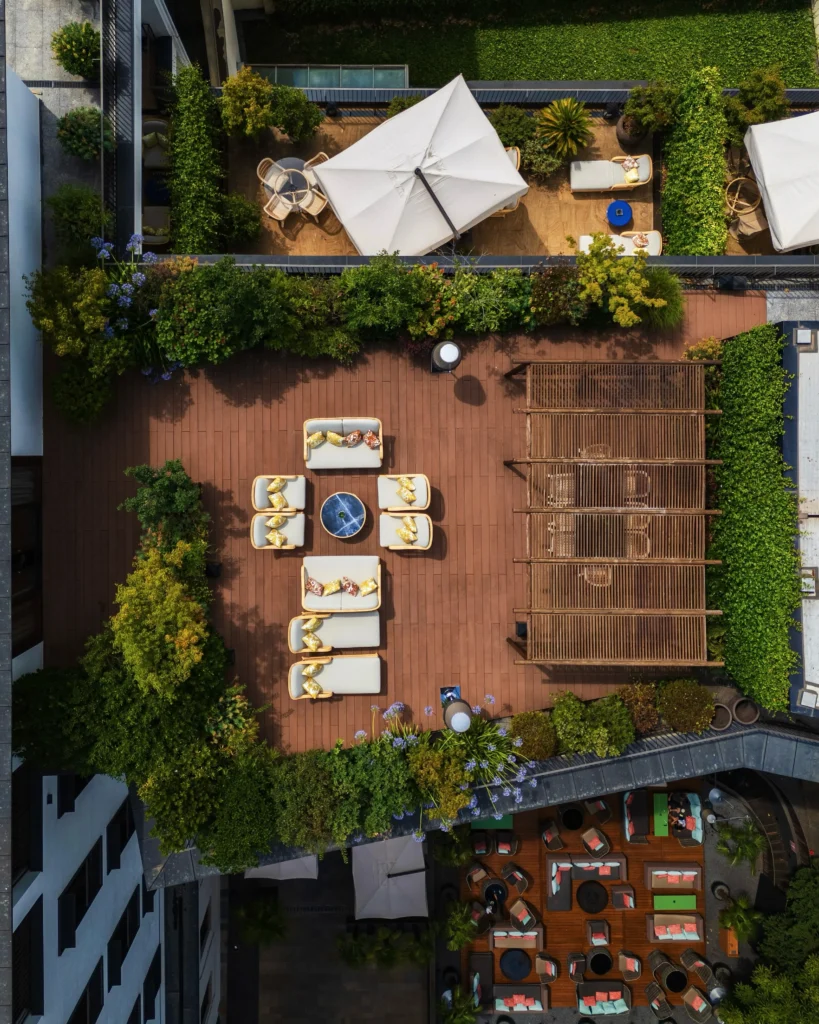 Aerial view of the landscaped garden courtyard with outdoor dining areas at Bulgari Hotel Milano