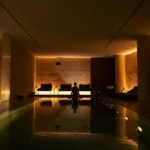Indoor spa swimming pool illuminated by warm ambient lighting at Bulgari Hotel Milano