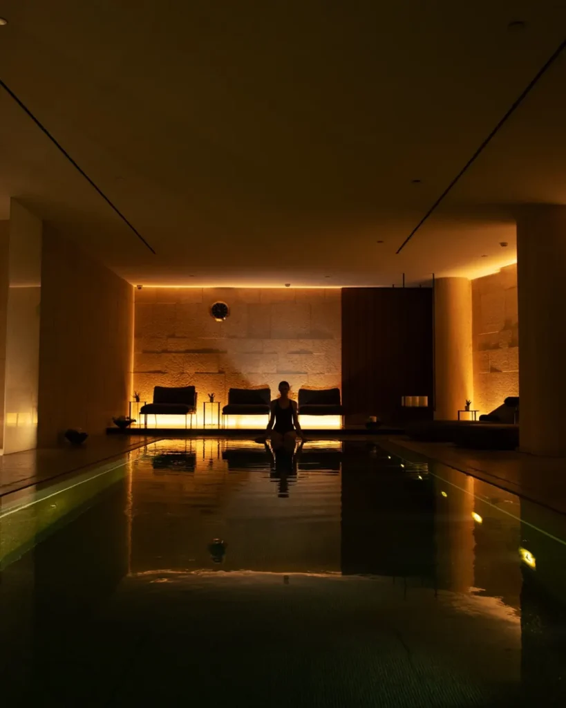 Indoor spa swimming pool illuminated by warm ambient lighting at Bulgari Hotel Milano